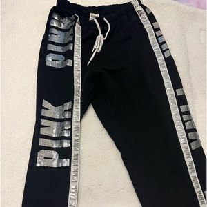 VS Pink black sweatpants with sequin lettering down both sides.
